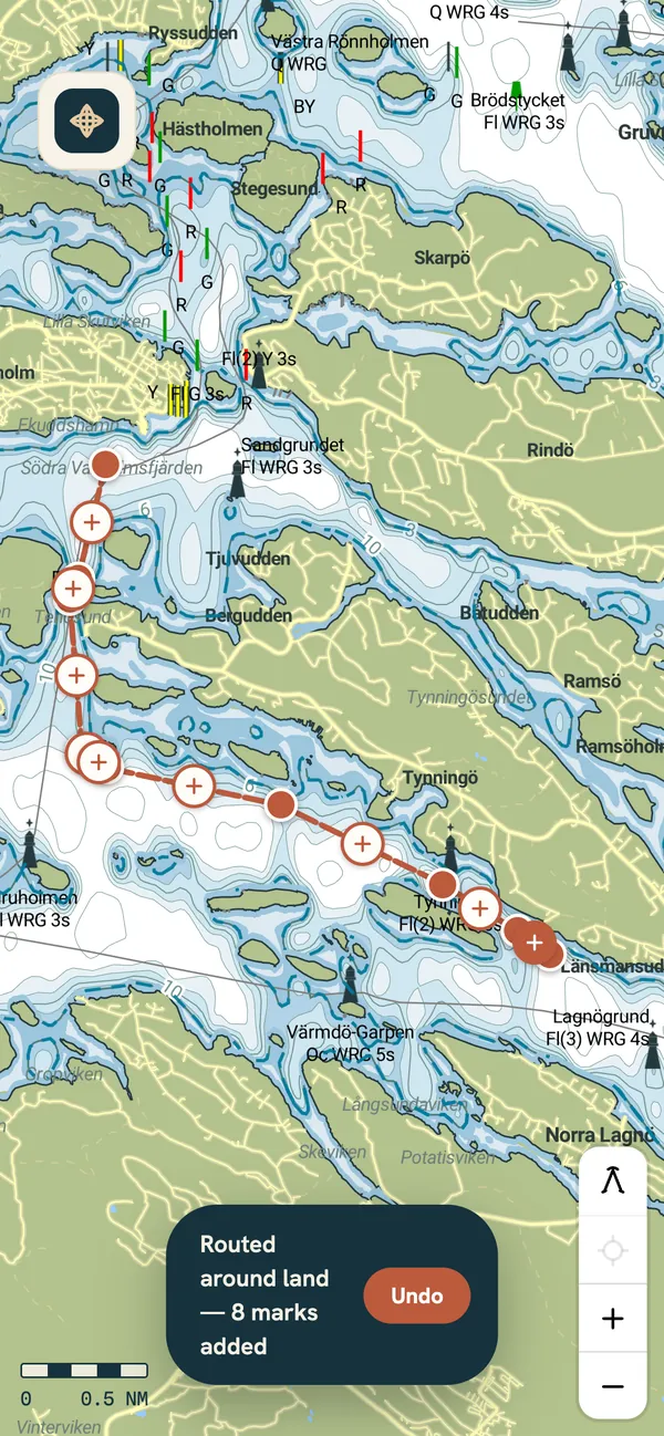 OpenHelm chart of the Vaxholm archipelago: a two-mark route re-routed round the islands through Tenösund, with the notice “Routed around land — 8 marks added” and an Undo button.